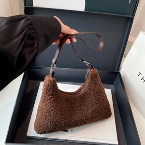 Deep brown teddy fleece tote bag with leather handles in a luxury gift box display