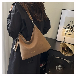 Brown textured leather hobo bag with gold logo and detachable mini pouch detail