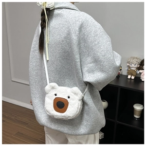 Detail of white plush bear crossbody bag showing soft faux rabbit fur and cute cartoon design