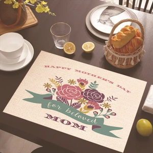 Linen placemat with floral Happy Mother's Day design on a dark wood dining table