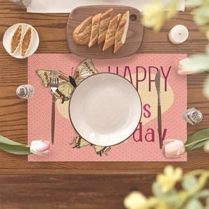 Linen placemat with pink butterfly and Happy Mother's Day design on dark wood table