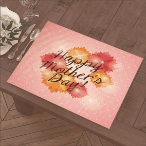 Linen placemat with Happy Mother's Day floral print on wooden table setting