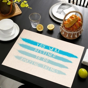 Close-up of linen table mat with inspirational text on a rustic wooden dining table