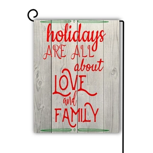 Detail of linen garden flag with wood texture and holiday slogan on metal stand