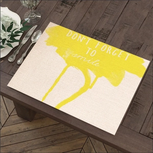 Modern linen placemat with yellow splash design and Don't Forget To Smile text