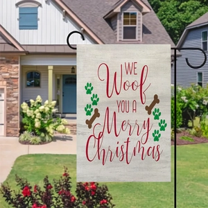 Close-up of double-sided Christmas garden flag with dog paw prints and bone patterns