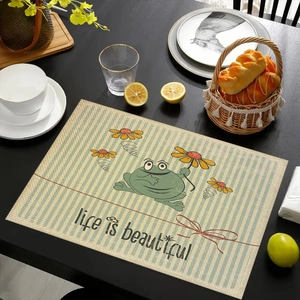 Linen placemat with cartoon frog design and 'life is beautiful' text on striped background