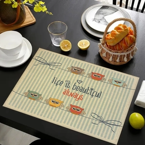 Detailed view of linen placemat featuring colorful owls and life is beautiful text
