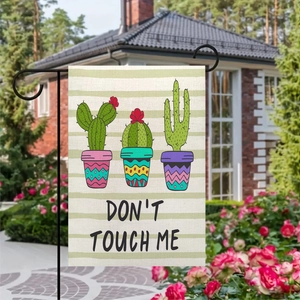 Detail of linen garden flag with cactus design and Don't Touch Me text in a garden