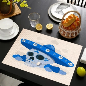 Close-up of linen-textured placemat with blue sugar skull pattern on a dining table