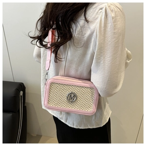 Detail of pink leather trim and beige woven texture on crossbody bag with M logo