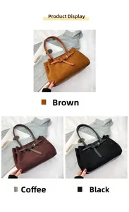 Three suede tote bags in brown, coffee, and black with buckle straps and long handles