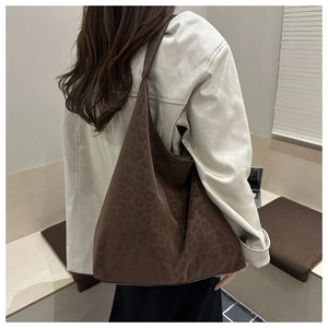 Detail of soft leopard print tote bag in dark brown suede showing large capacity and texture