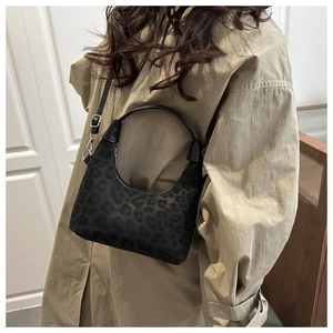 Dettaglio borsa hobo leopardata nera in pelle scamosciata con finiture metalliche argento