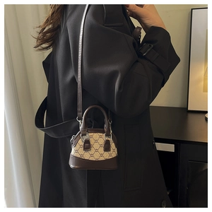 Model view of a vintage mini crossbody bag in monogram canvas and dark brown leather