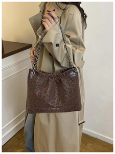 Detail of leopard print tote bag with silver chain strap and ruched cloud design