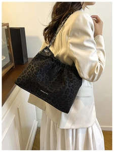 Leopard print tote bag with silver chain strap and Creative Cat logo on model