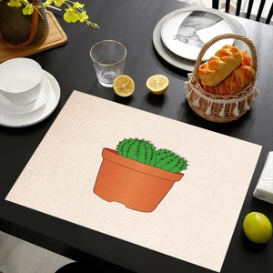 Tovaglietta in lino con stampa cactus su tavolo nero con decorazioni da pranzo