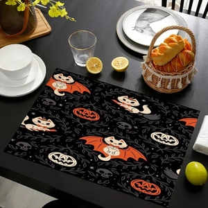 Detail of Halloween linen placemat with pumpkin and witch cat print on wooden table