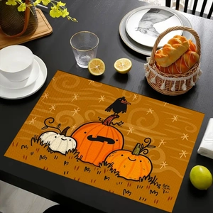 Detail of Halloween pumpkin placemat with crow print on dark wooden dining table