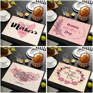 Set of four Mother's Day linen placemats with floral and heart prints on a wood table