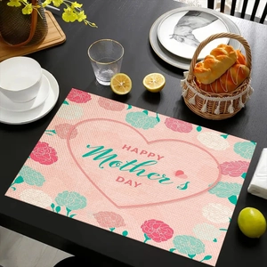 Linen placemat with Happy Mother's Day text and pink carnations on a dark wood table