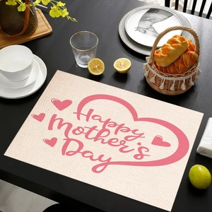 Linen placemat detail with Mother's Day heart print on a table with dishes