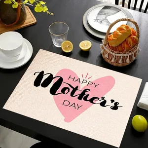 Linen placemat with Happy Mother's Day heart print on black wooden dining table