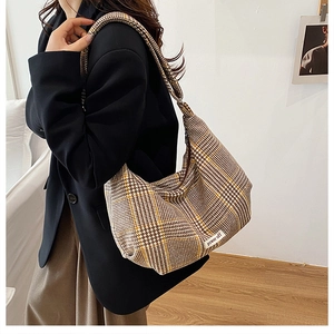 Detail of checkered tweed hobo bag featuring large capacity and a power off patch