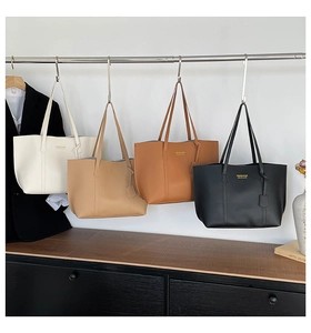 Detailed display of high-capacity tote bags in four neutral colors on a display rack