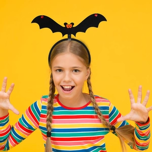 Close-up of Halloween bat headband worn by a child with colorful festive details