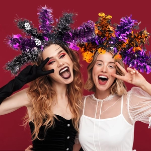 Close-up of Halloween headbands with skull and pumpkin icons worn by festive models