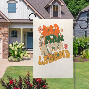 Close-up of Dad The Man Myth Legend garden flag hanging on a black stand in a yard