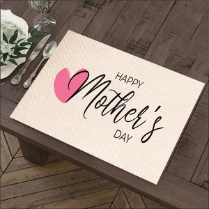 Linen placemat with pink heart and Mother's Day text on dark wooden table