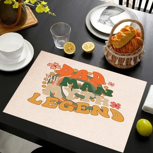Detail of linen placemat featuring retro Dad The Man Myth Legend text on a wooden table
