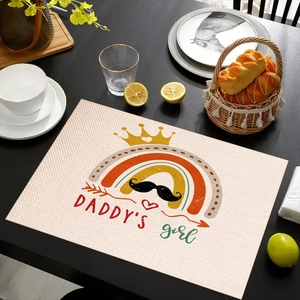 Close-up of linen place mat featuring DADDY'S girl text and crown illustrations