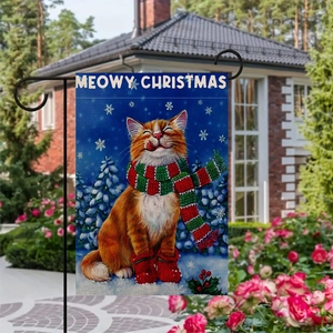 Meowy Christmas garden flag with a cat in scarf and boots displayed in a backyard