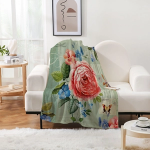 Detail of vintage butterfly floral flannel blanket draped on a white sofa in a cozy room