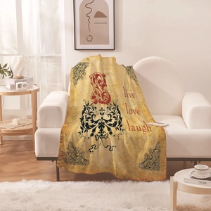 Vintage floral tapestry blanket with Live Love Laugh quote draped on a modern white sofa
