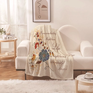 Detailed texture of flannel blanket with colorful floral print and bible verse John 10:10