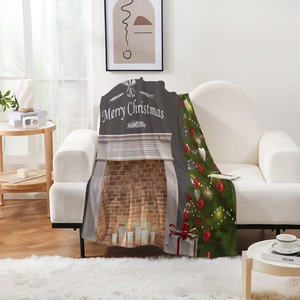 Cozy flannel Christmas blanket featuring fireplace and tree decor draped on a white sofa
