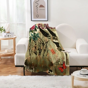 Vintage floral butterfly flannel blanket draped on a white sofa in a cozy modern living room