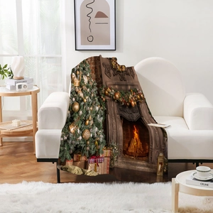 Detail of soft flannel Christmas blanket with tree and fireplace print on a sofa