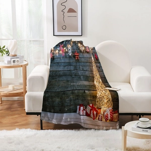 Detail of soft flannel blanket featuring festive Christmas tree and vintage wood print