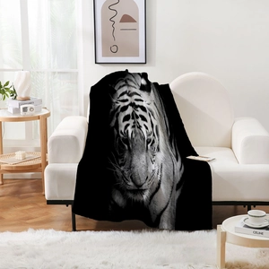 Detail of soft flannel throw blanket featuring a realistic black and white tiger head art print