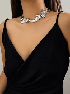 Detail view of irregular liquid lava style silver choker necklace on female model