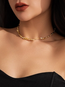 Detailed view of the gold irregular lava texture choker on model's neck for high fashion look