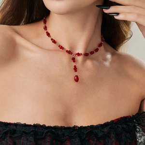 Macro shot of Gothic red crystal beaded necklace with water drop pendant and silver clasp