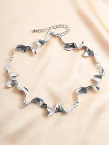 Detail shot of silver liquid lava texture choker on premium pink silk background