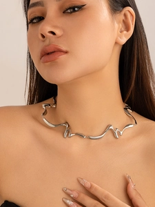 Close-up of irregular silver liquid lava choker necklace worn by a female model